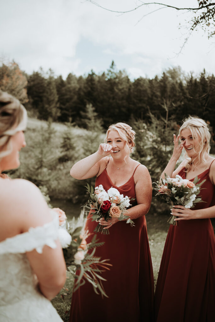 wedding photo of the bridesmaids getting emotional over the "first look" moment