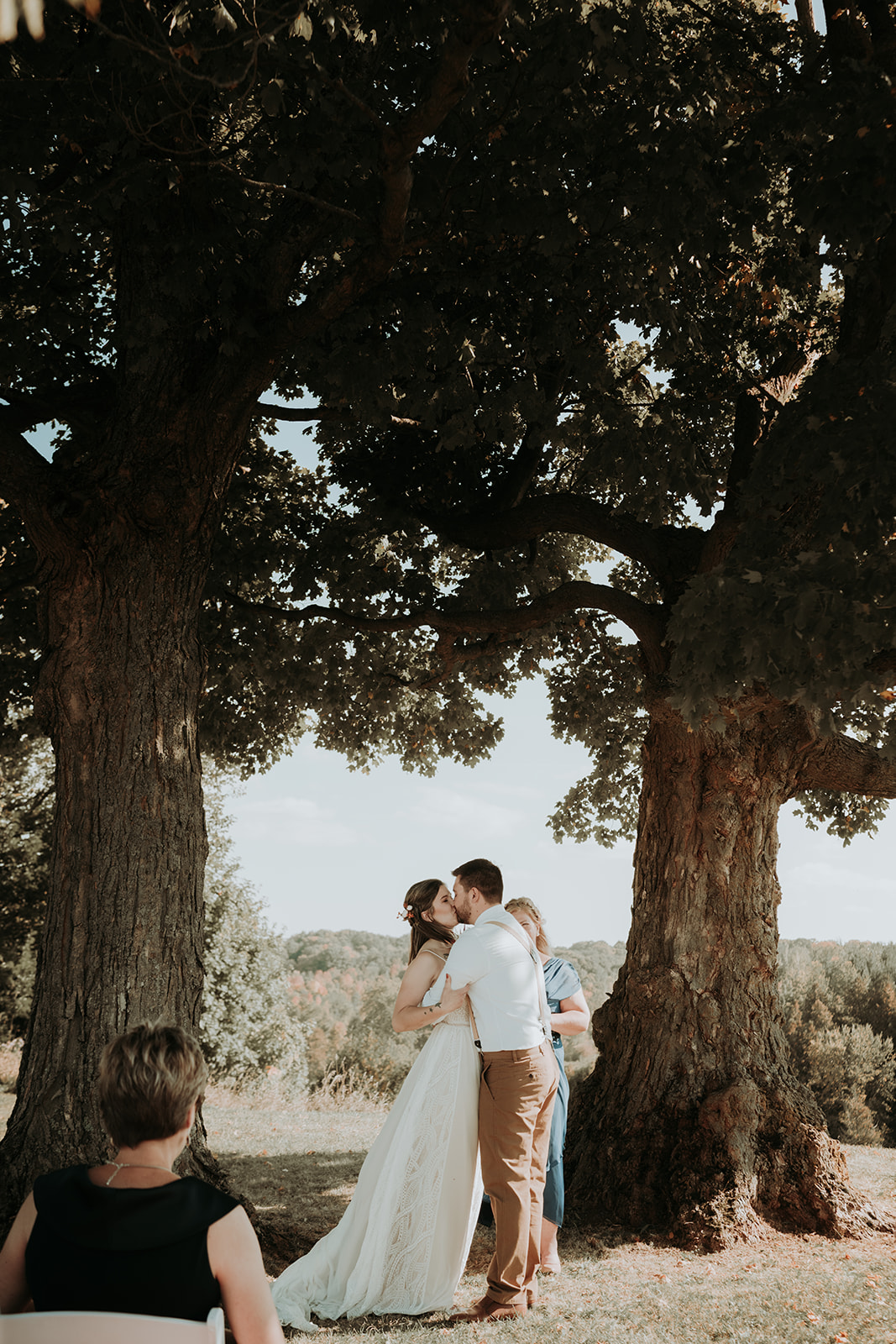 a wedding photo of a couple with their "first kiss"