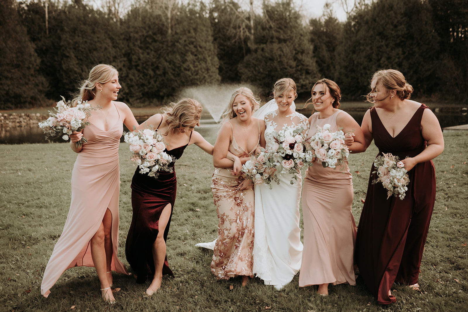 a wedding group photo of the bride with her bridesmaids