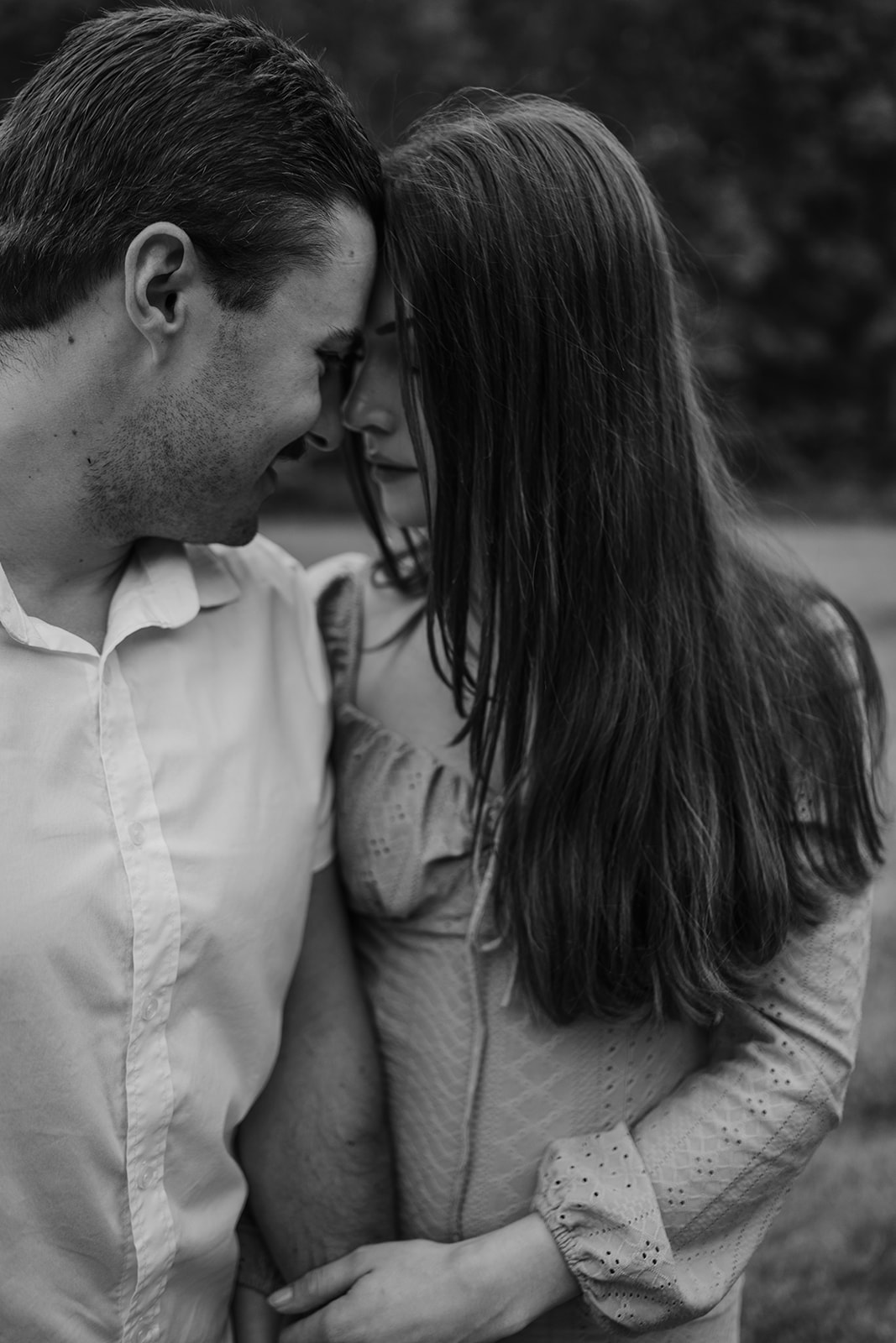 couple pose:  foreheads touching in a black and white photo