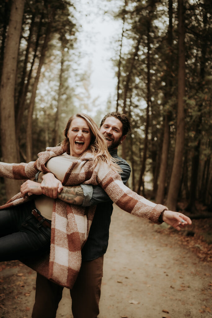 couple pose: a man playfully spins the woman from behind.