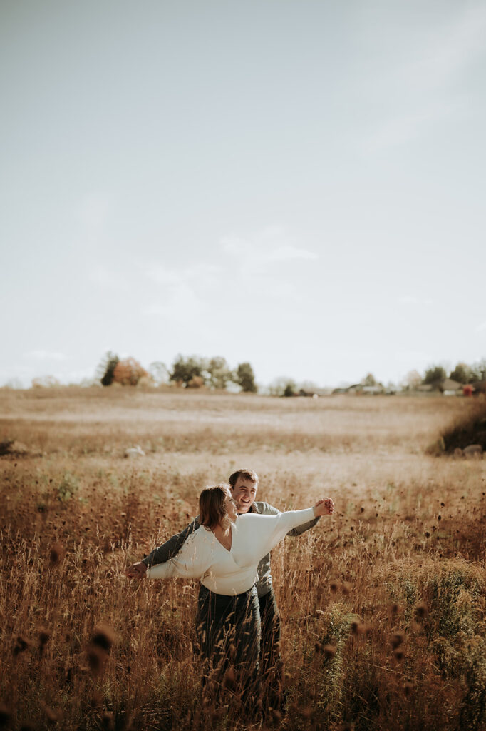 couple pose: arms stretched and fingers interlocked like an airplane.