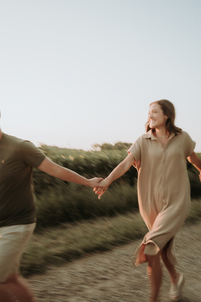 couple pose: couple running hand in hand excitedly.