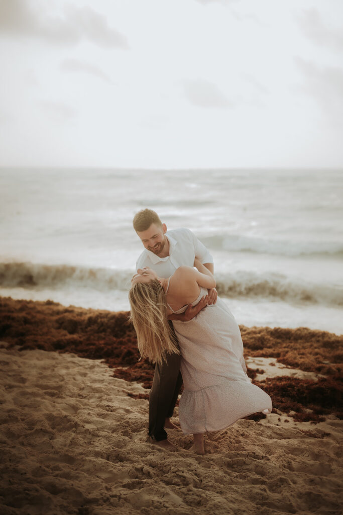 couple pose: man playfully dips the woman backward.